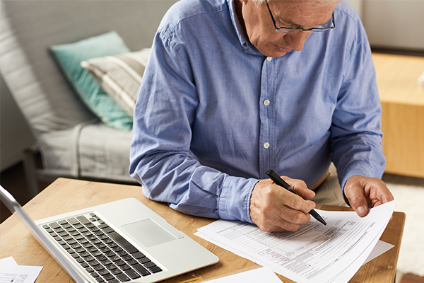 An old man writing paper