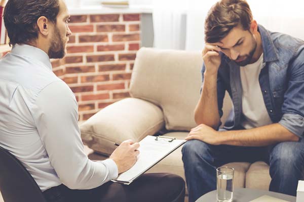 man sitting in a psychiatrist office