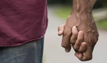 Two people holding hands