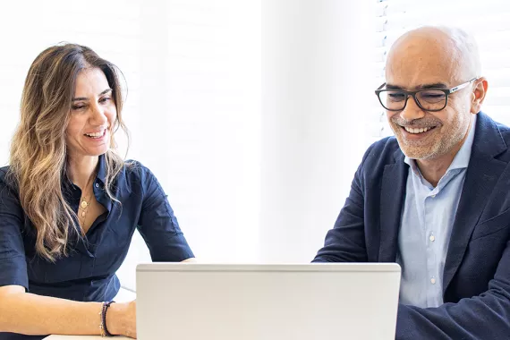 Man and woman behind computer