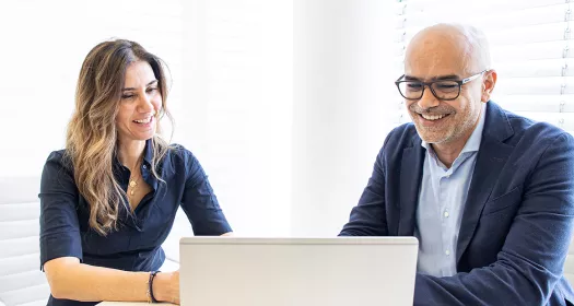 Man and woman behind computer