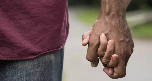 Two people holding hands