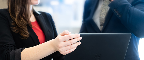 Woman showing screen of laptop