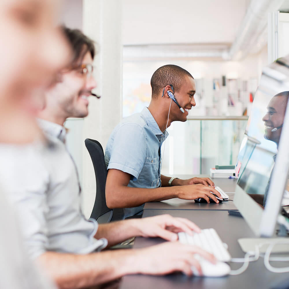 Customer service employees at computers taking calls