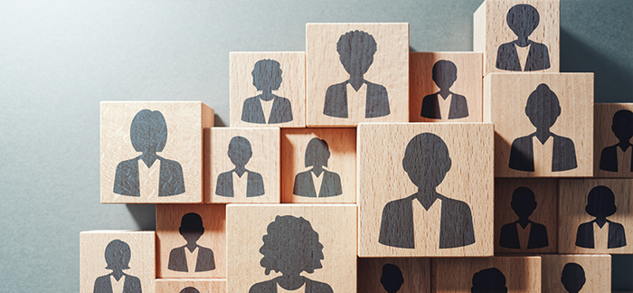 Wooden block with faces of men and women