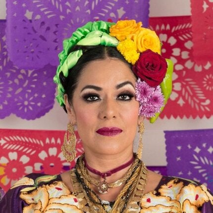 Lila Downs wearing large flower headpiece