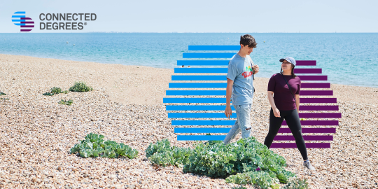 Two students walking on the sunny beach. Connected Degrees logo is top left.