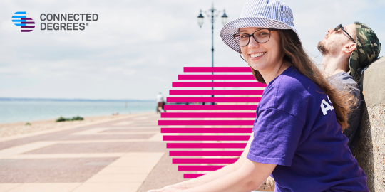 Two students sat at the beach in Portsmouth. There is a Connected Degrees logo top left. 