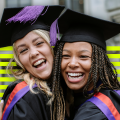 Two students wearing graduation caps