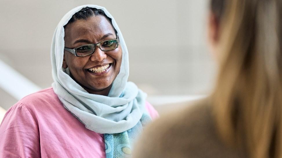 A Reckitt employee smiles at her colleague