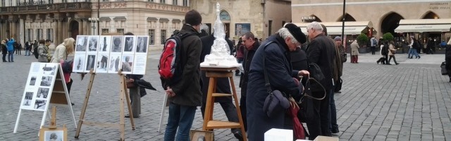 La asociación que fomenta la Columna Mariana recoge donativos con un sencillo tenderete en la plaza y un modelo y fotos del proyecto.