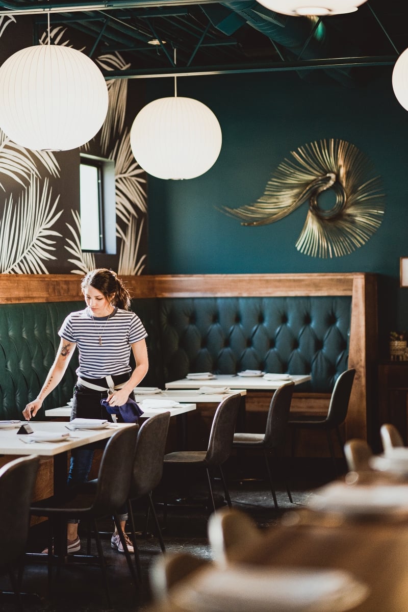 "The peacock is our spirit animal," Peterson says. MTA Hospitality designers Whitney Johnson and Leslie Hoffeditz used peacock teal as the dominant color in the dining room, and a vintage brass peacock (a gift from a friend of Peterson's) adorns a wall. George Nelson bubble lamps add to the restaurant's mid-century look.