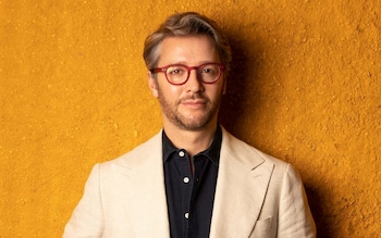 Artist, architect and hotelier Jacu Strauss wears a Giuliva Heritage blazer and Izipizi glasses