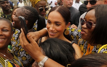 The Duchess is seen posing for selfies in a press of women