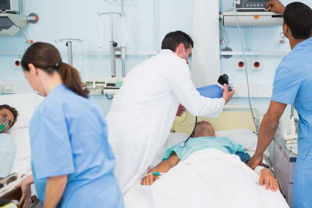 Critical Care hospital room with patients and staff