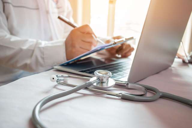 Doctor at his desk with laptop