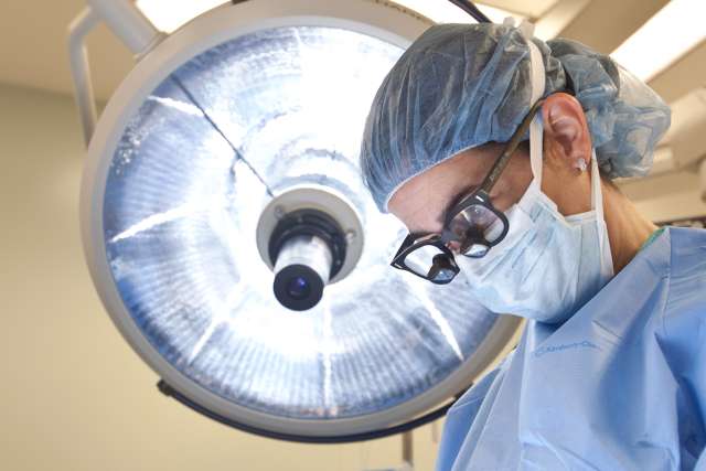 Woman doctor performing surgery