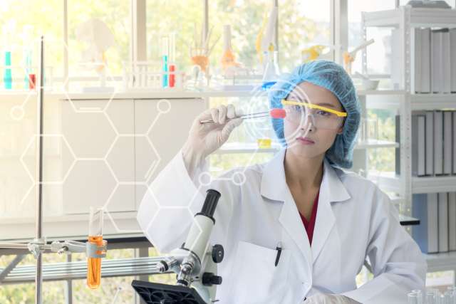 Cancer researcher holding test tube in lab