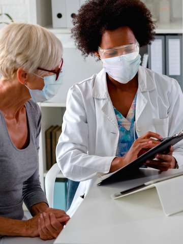 Female patient registration at front desk checking in