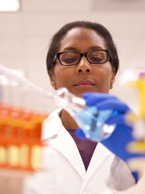 A doctor holding a beaker in lab.