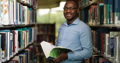 StayCurious - Researcher reading in library