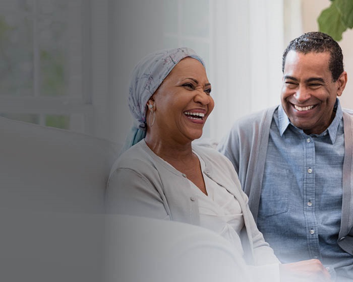 Elderly couple laughs together