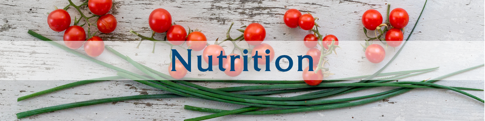 nutrition cherry tomatoes and chives on a white washed wood table