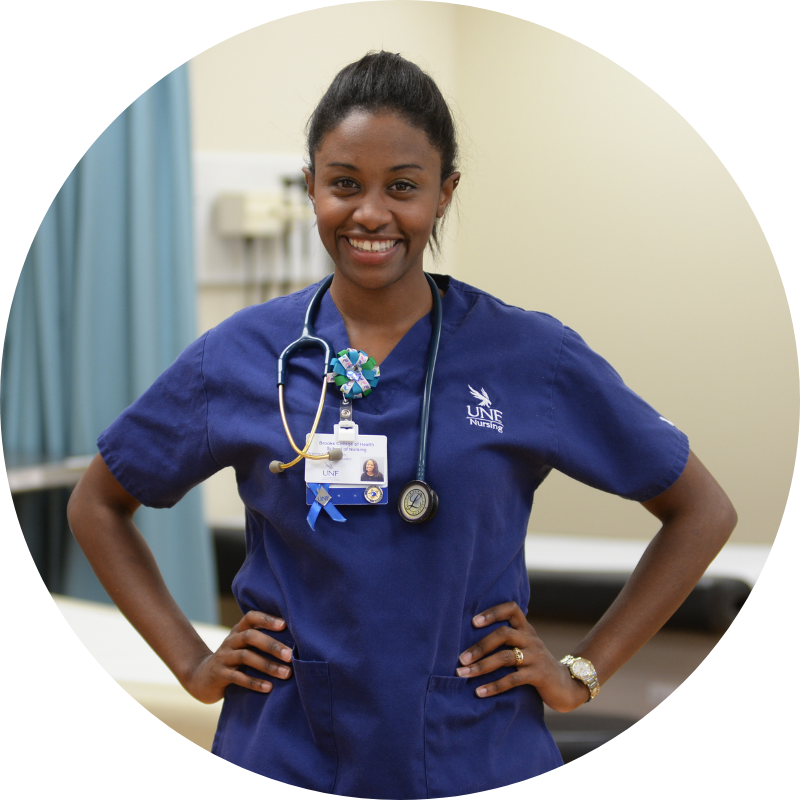 UNF Nursing Student standing and smiling with her hands on her hips