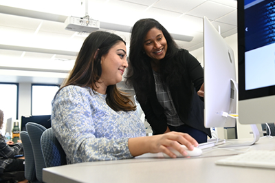 faculty and student looking at computer screen