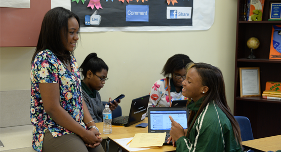 Teacher conversing with student