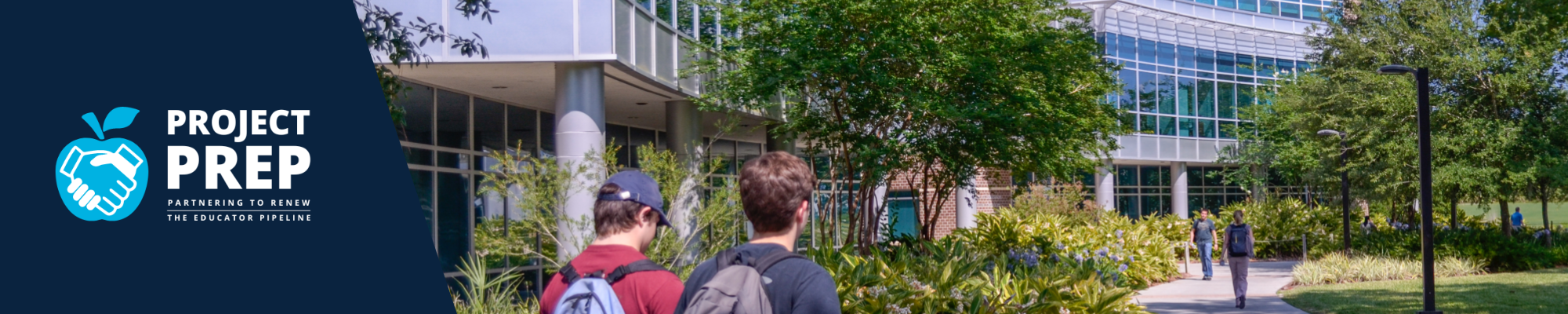 students walking on campus by the coehs building