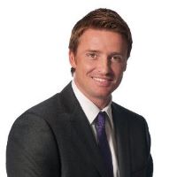 Headshot of Joffrey Heine with suit and purple tie and white background