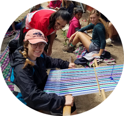 UNF student weaving in Peru with local woman and classmates watching