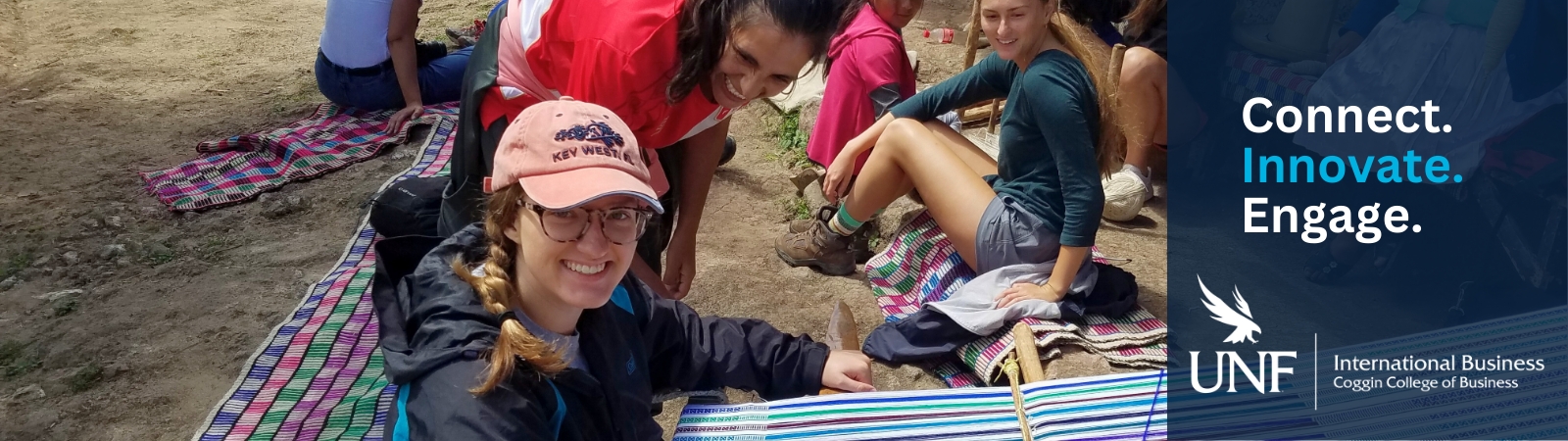 a Coggin student weaving in Peru with a local woman assisting