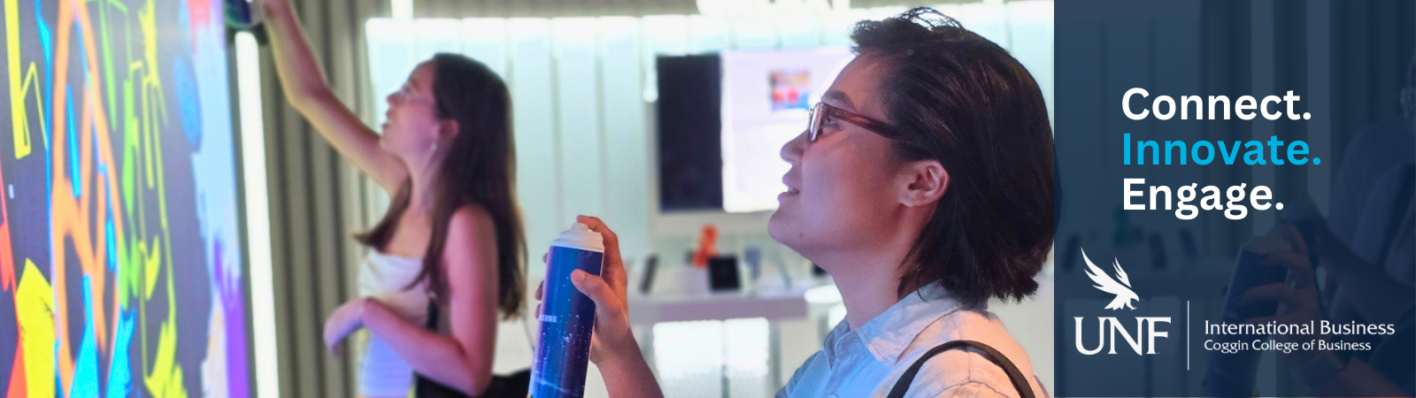 two GlobalMBA students interacting with a spray-paint board at Samsung