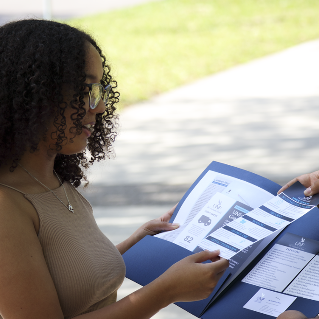 student receiving marketing materials from graduate school