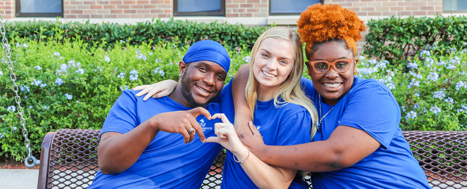 residents making hearts with each others hands and smiling on a beautiful day