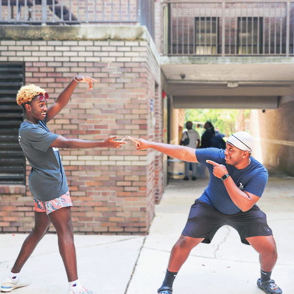 two residents smiling outside of residents halls 