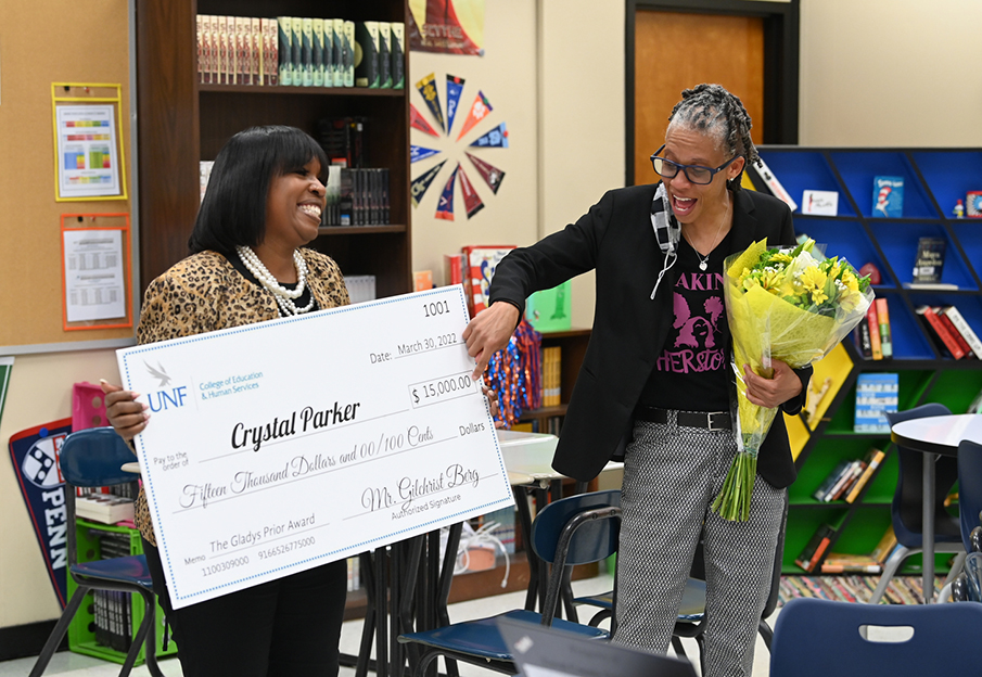 Gladys Prior recipient Crystal Parker smiling while holding flowers