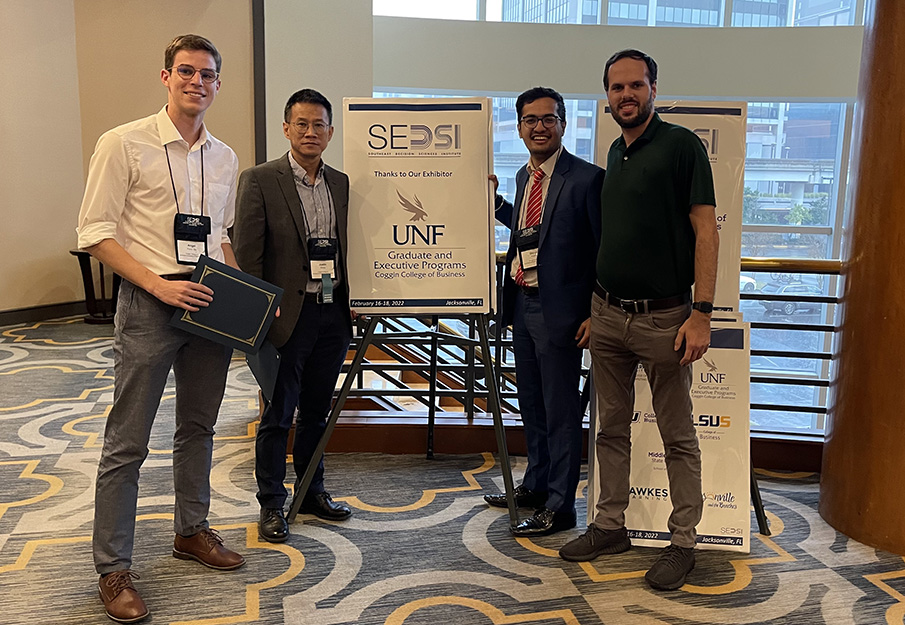 SEDSI students posing for a photo with a UNF sign