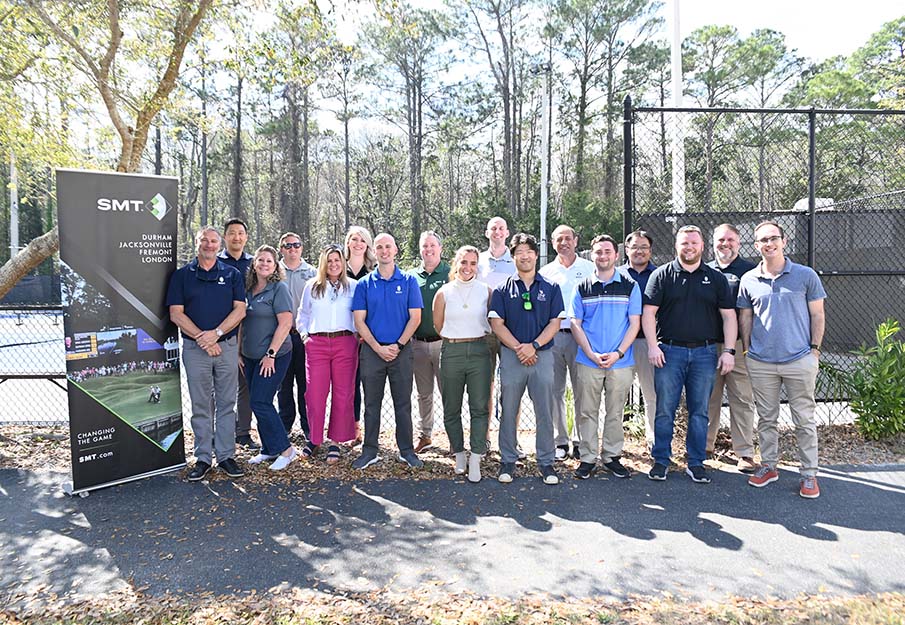 A group of Sport Data Analytics Lab members and representatives from SportsMEDIA Technology by a tennis court