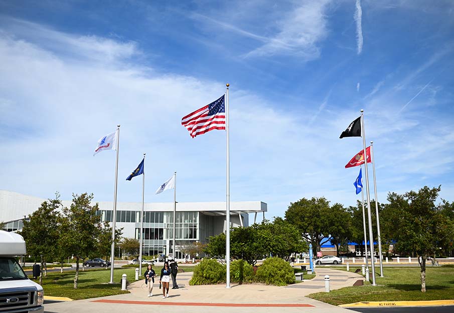 Veterans Plaza on a sunny day with lots of students walking by.