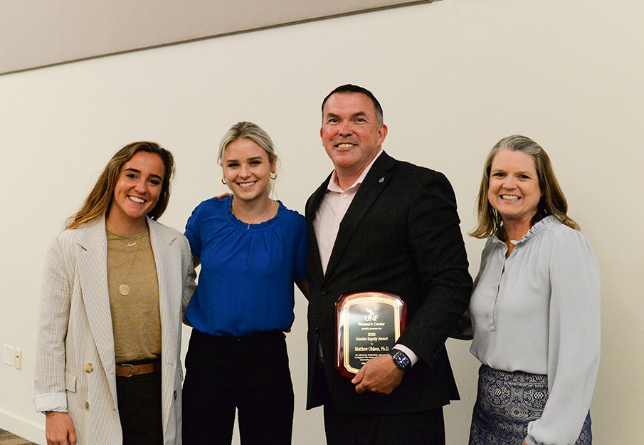 Dr. Matthew Ohlson, Ana Roman Dominguez and two others posing for a photo at the Women's Center Awards.