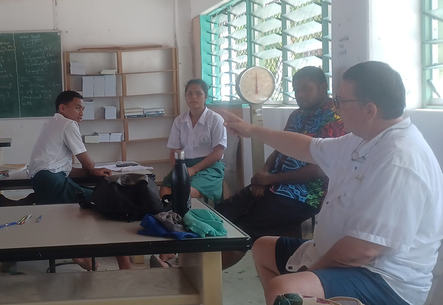 Dr. Cavanaugh talking to students from Tuvalu in their classroom