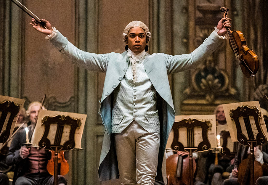 Actor who played Chevalier in the film based on the composer's story posing with a violin in his hand. Photo credit from IMDb.