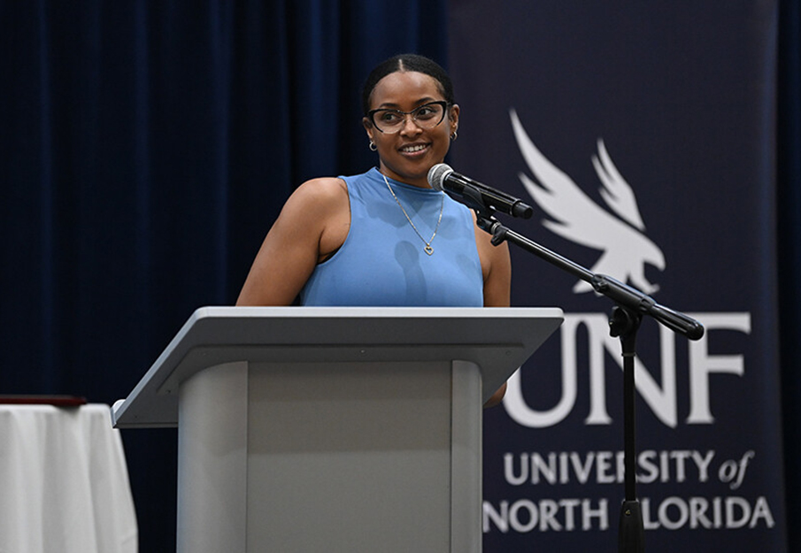 Student speaking behind a podium