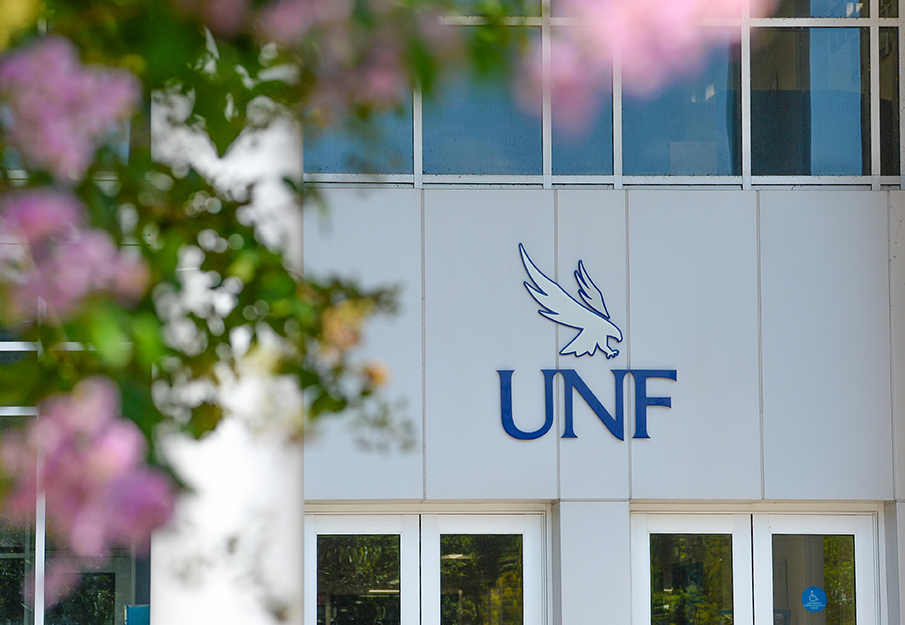 UNF sign with pink flowers in foreground