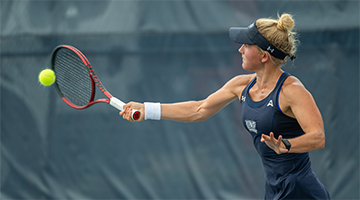 Annabelle Davis hitting a tennis ball with a racquet