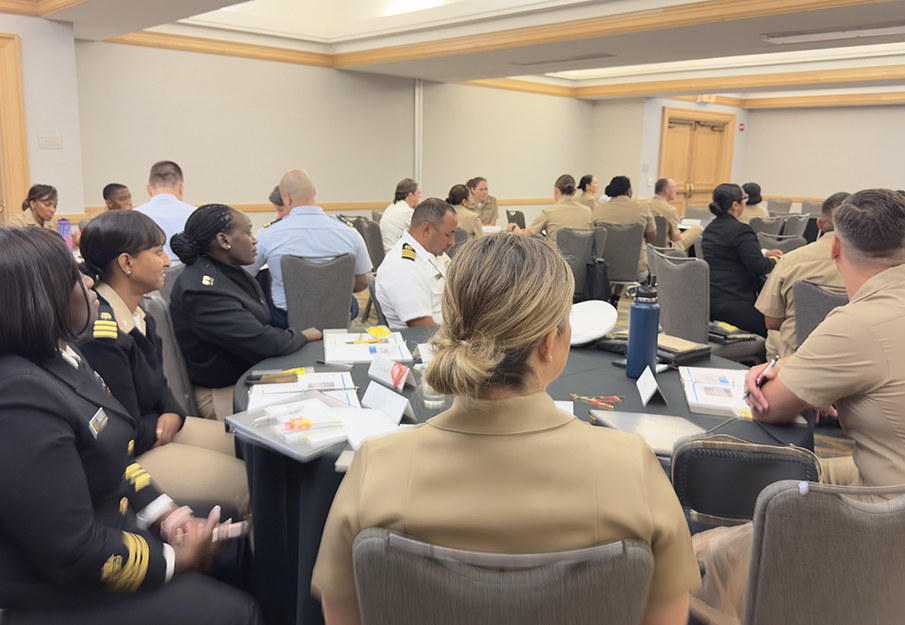 A table of commissioned corps officers at the 57th Annual United States Public Health Service Symposium workshop