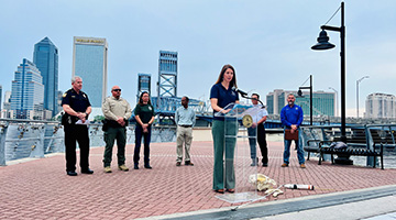 Dr. Quincy Gibson standing at a podium